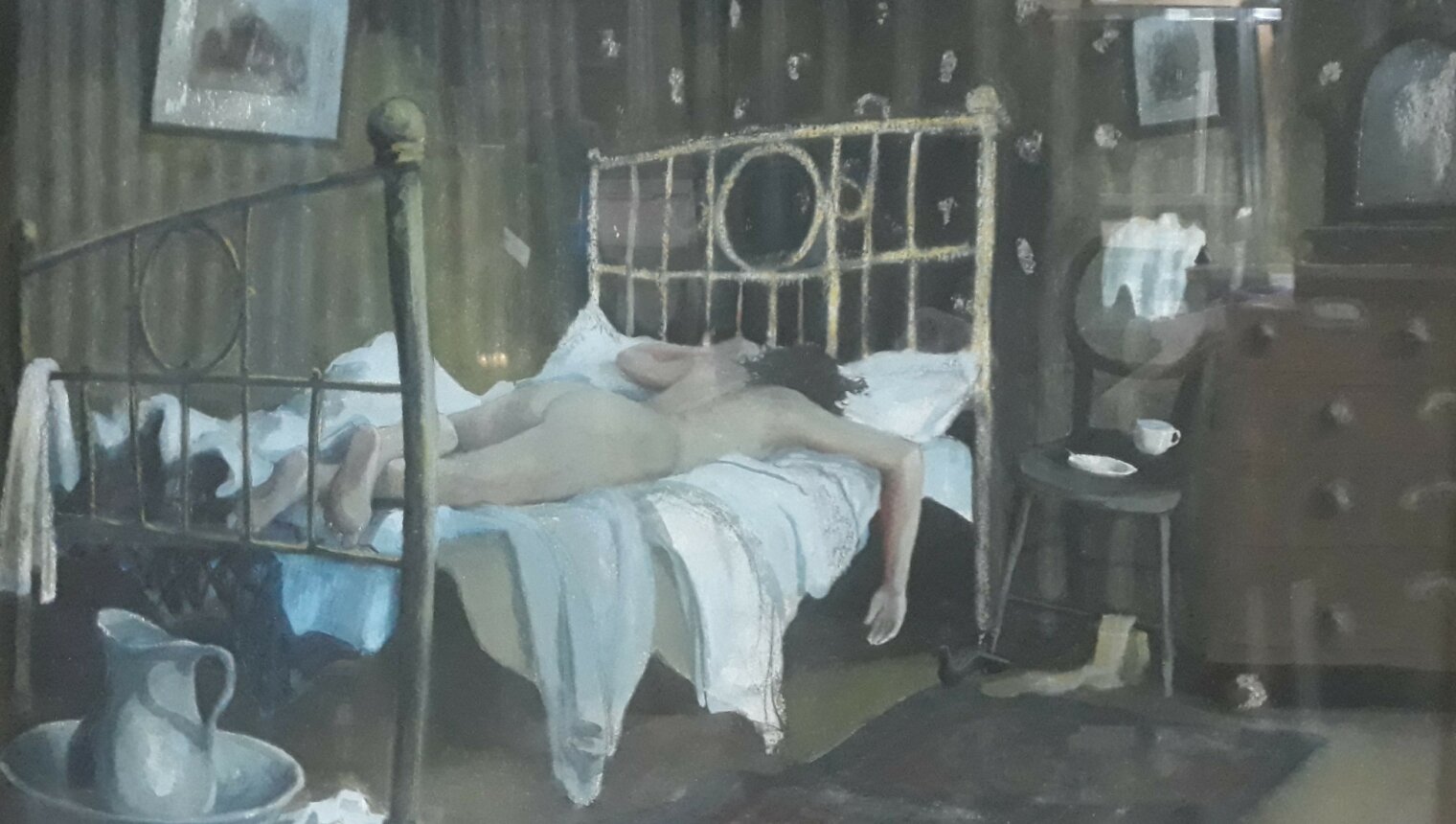 A painting of a nude body lying face down on a bed.