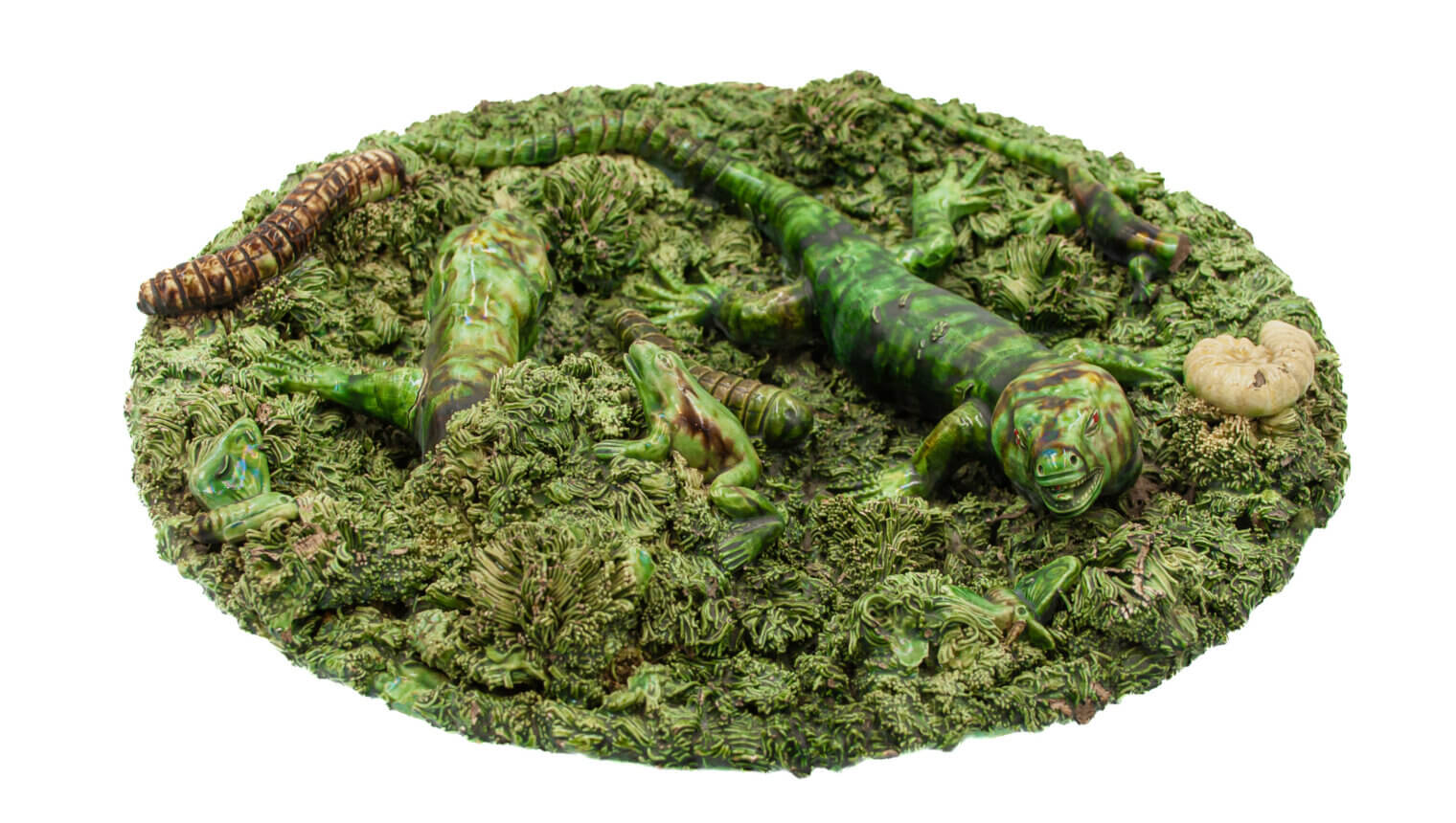 An ornate green dish made to look like lizards sitting on a mossy surface.