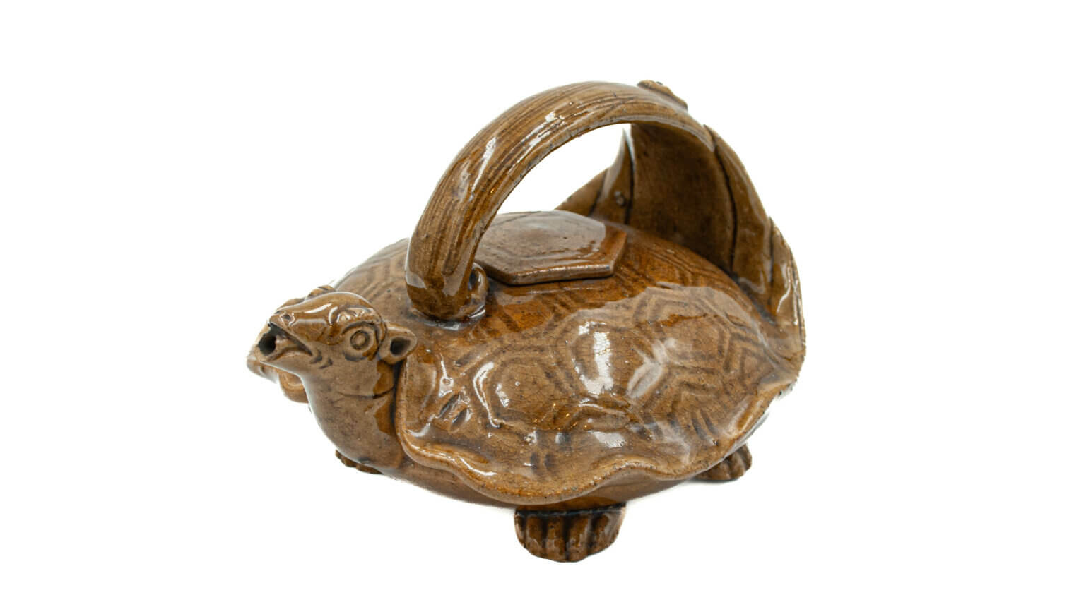 A shiny brown pot with a handle. It is shaped like a tortoise.