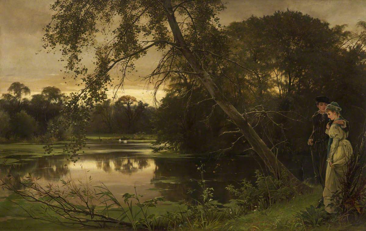 A couple stand in the shade of a tree, watching a the sunset reflect on a pond. The lady is point at herself, looking concerned.