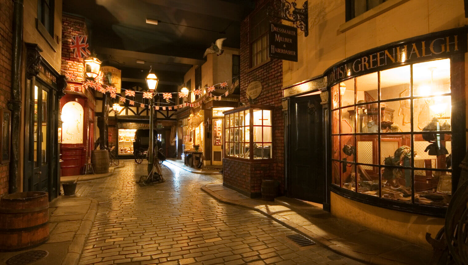 A fake street with old fashioned shop fronts and cobbled floors.