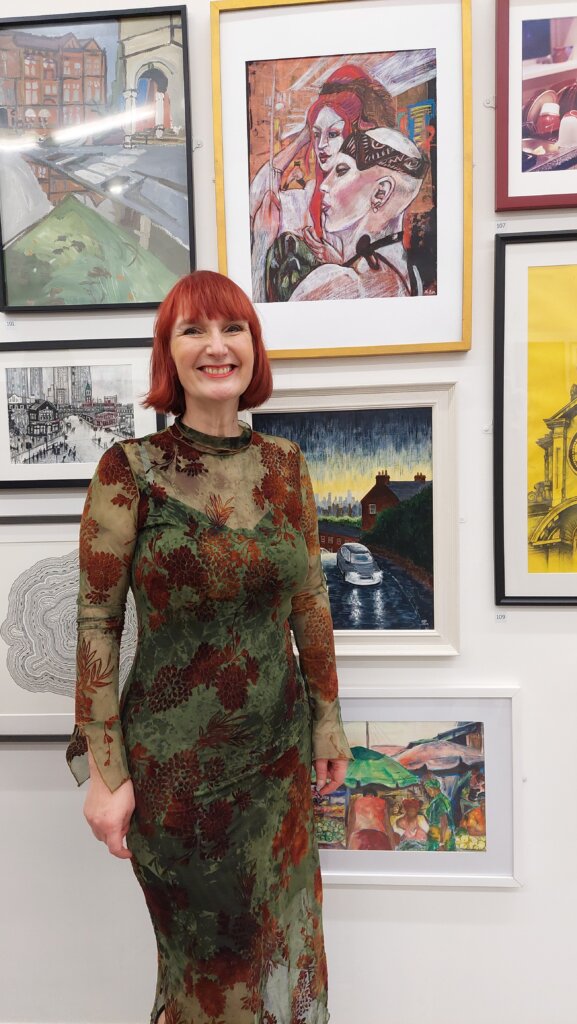 Artist standing next to winning artwork