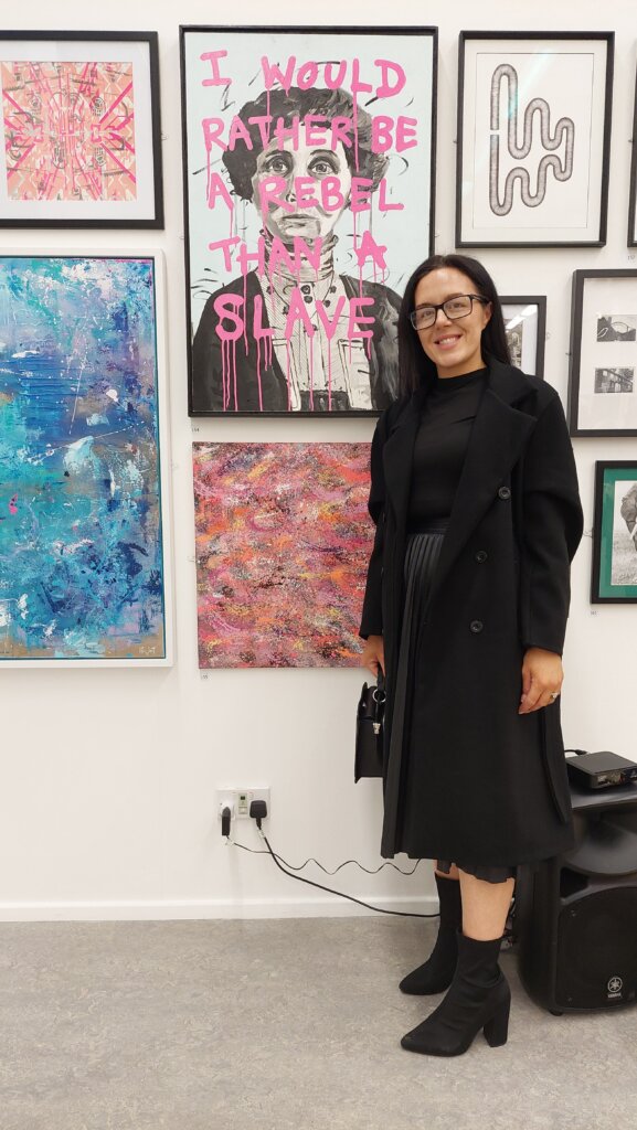 Artist standing next to winning artwork