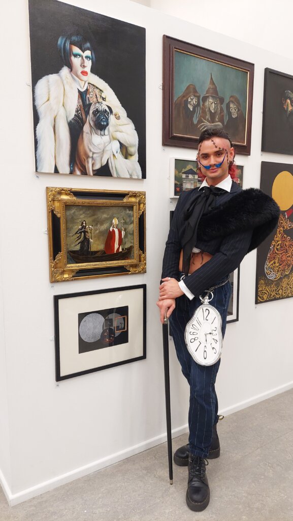 Artist standing next to winning artwork