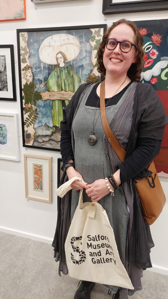 Artist standing next to winning artwork