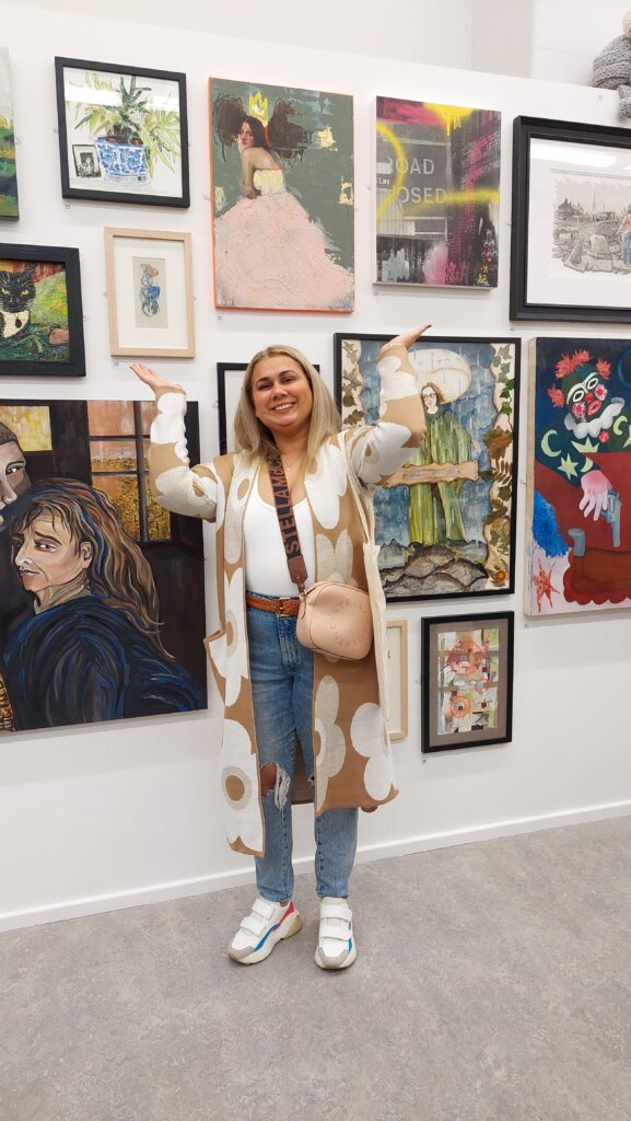 Artist standing next to winning artwork
