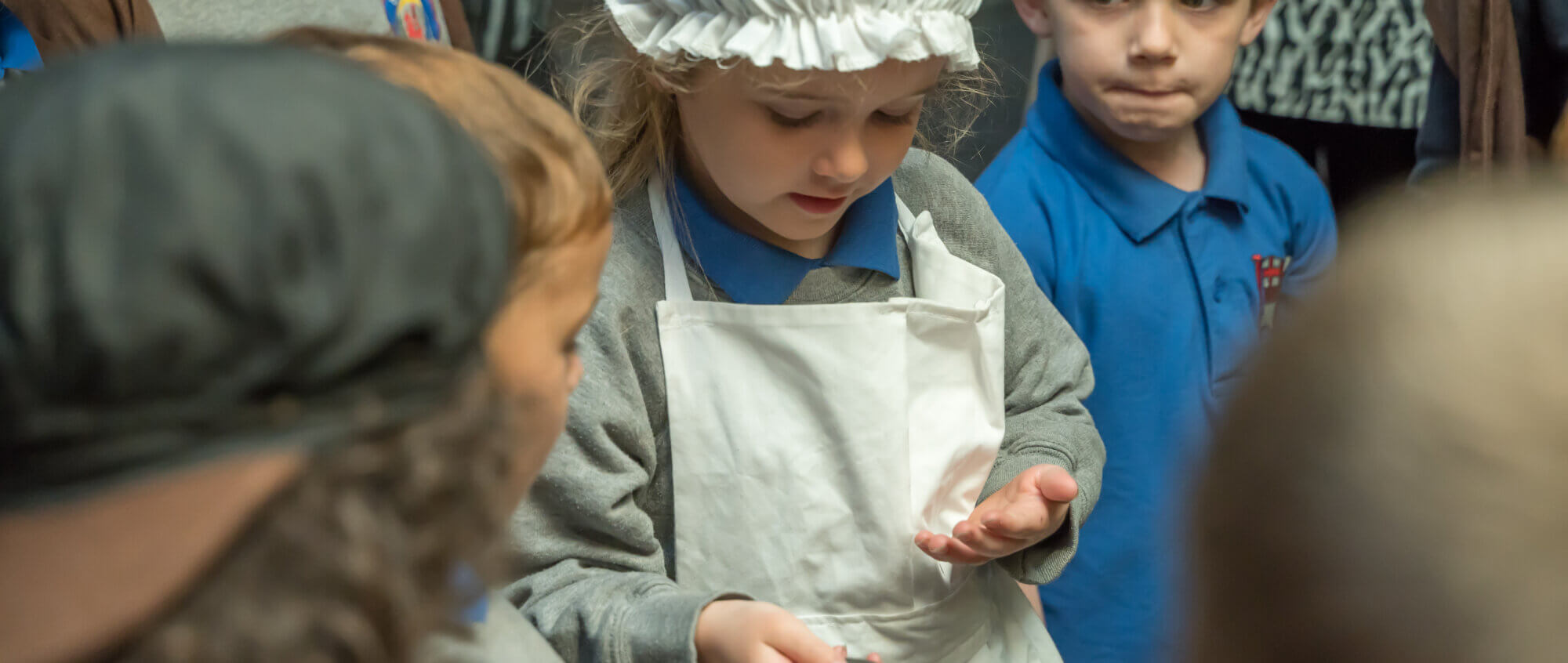 school children looking at objects