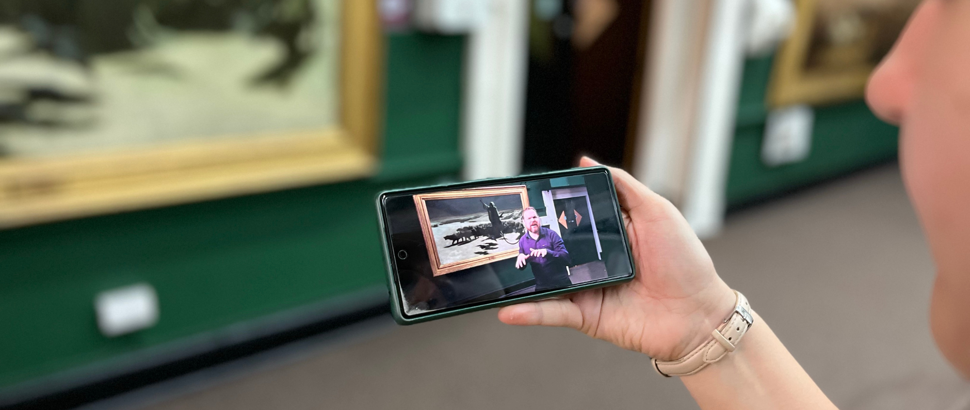 Person holding phone in gallery