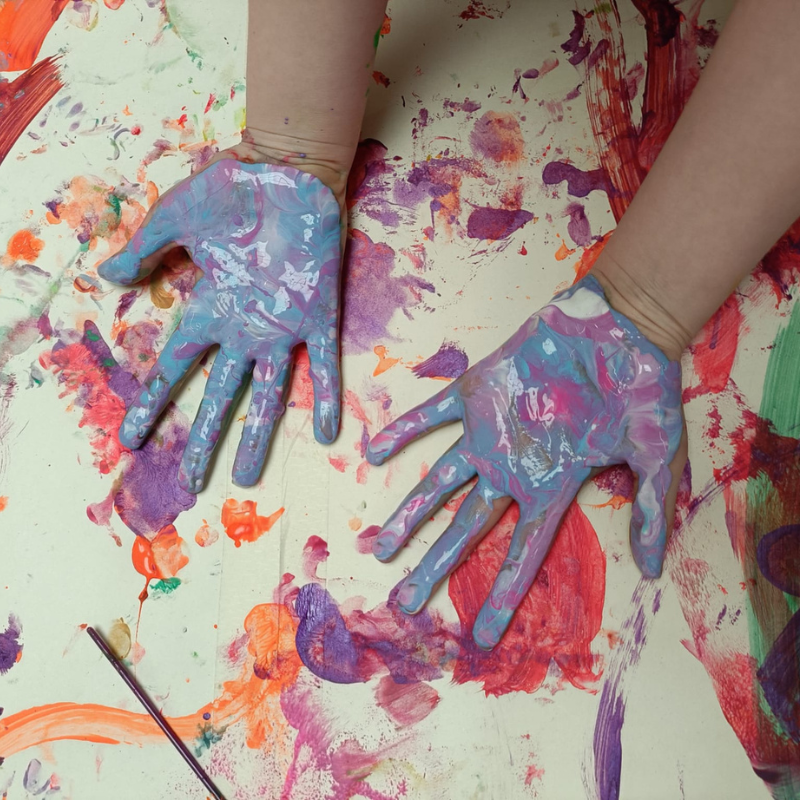 Hands covered in paint