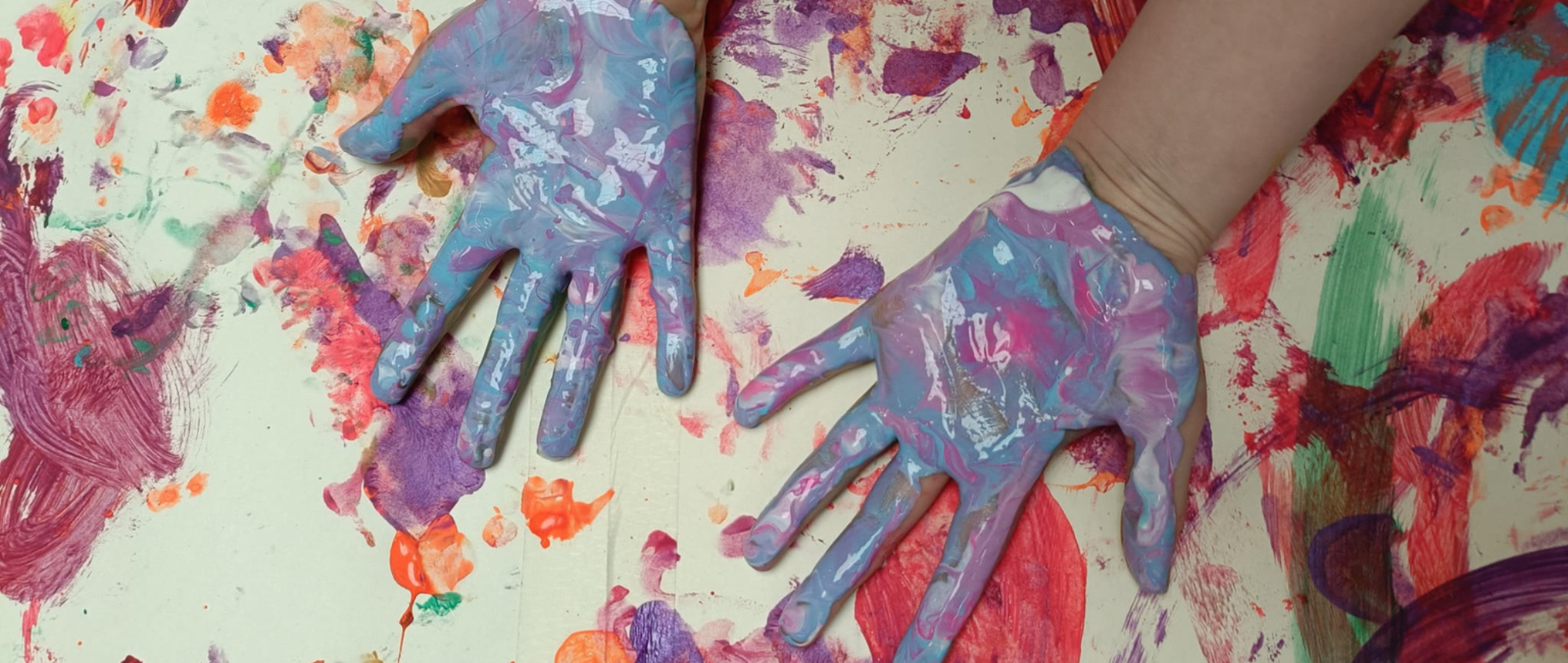 Hands covered in paint